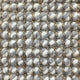 Thick gray and white wool-blend yarns form a textured grid, highlighting superior craftsmanship and natural fibre durability.