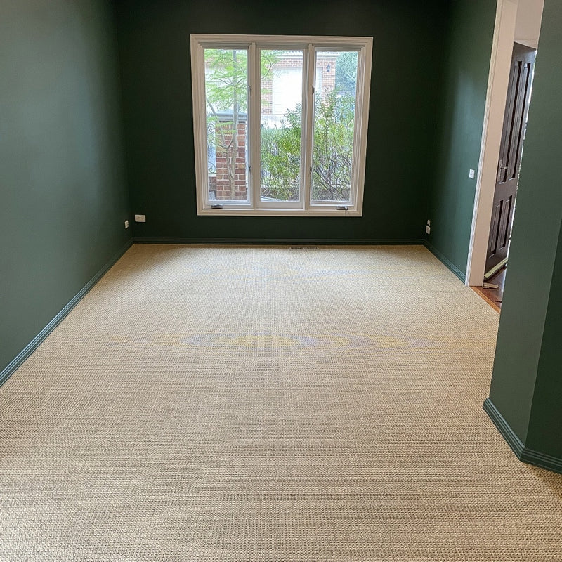 Serene room with green walls and a large window, featuring elegantly woven natural sisal flooring in Autumn Slate.