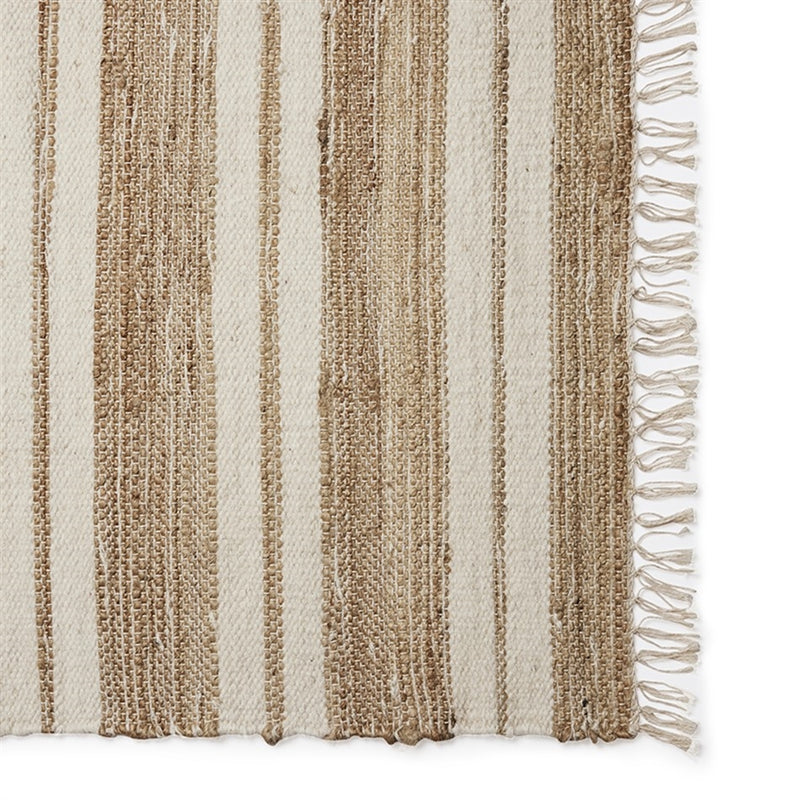 Beige and brown striped runner with a subtle right-edge fringe, crafted in natural fibres and styled on coastal-inspired flooring.