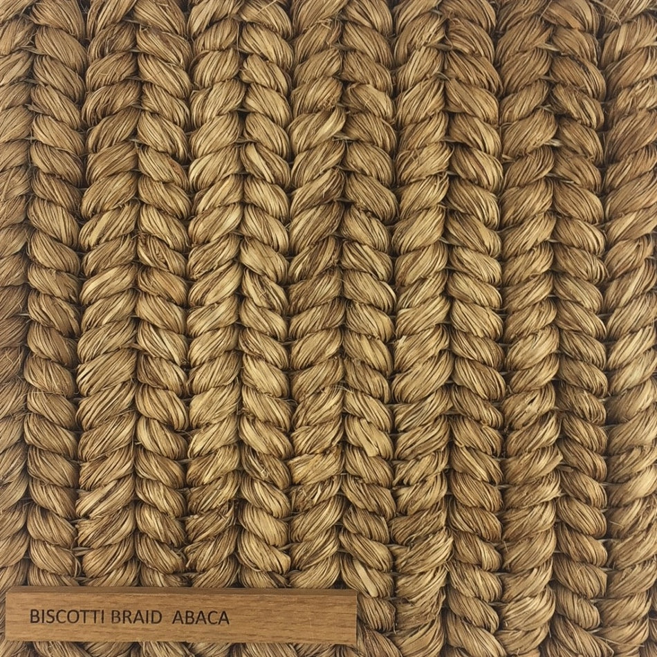 Thick, tan abaca fibers intricately braided, showcasing rich texture and artisanal craftsmanship in sustainable natural flooring.