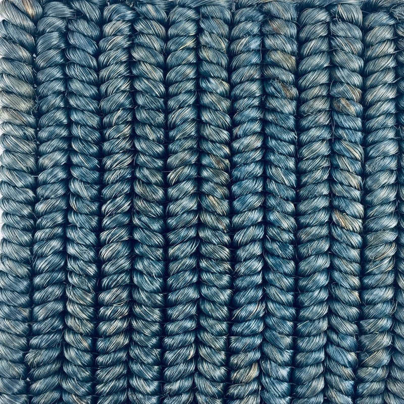 Vertically aligned, textured abaca strands in rich Bristol Blue showcase fine braid weave and artisanal craftsmanship.