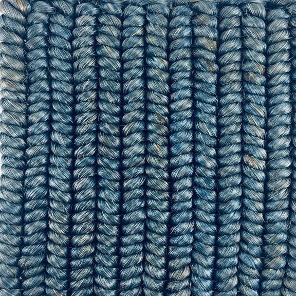 Vertically arranged blue braided abaca strands showcase fine craftsmanship and durable natural fibre in an elevated interior setting.