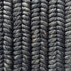 Detailed view of custom-dyed abaca in a dark, braid weave pattern; tightly woven cords highlight artisanal craftsmanship.