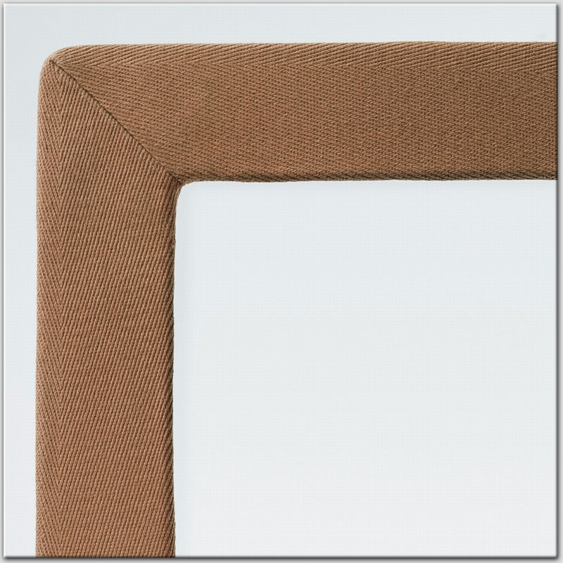 Detailed view of a finely woven cotton and linen rug border, highlighting natural texture against a soft neutral backdrop.