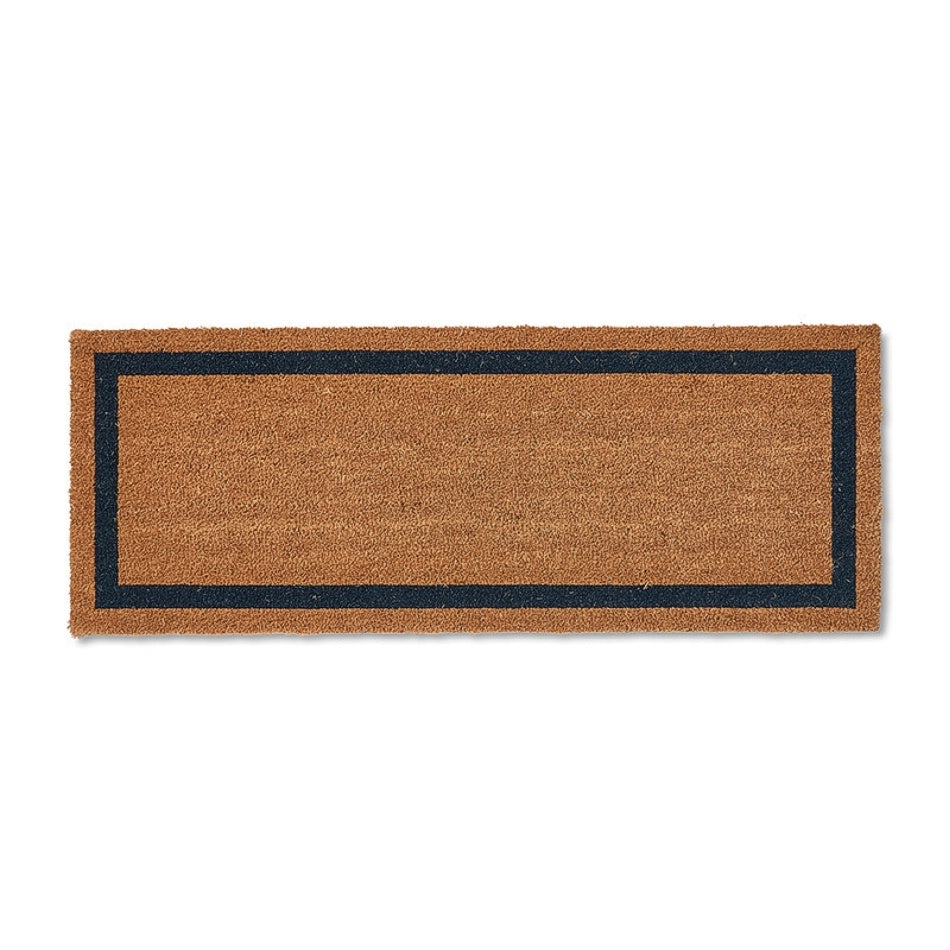 Rectangular brown coir doormat with a refined navy border, showcasing natural texture and quality craftsmanship on a smooth floor.