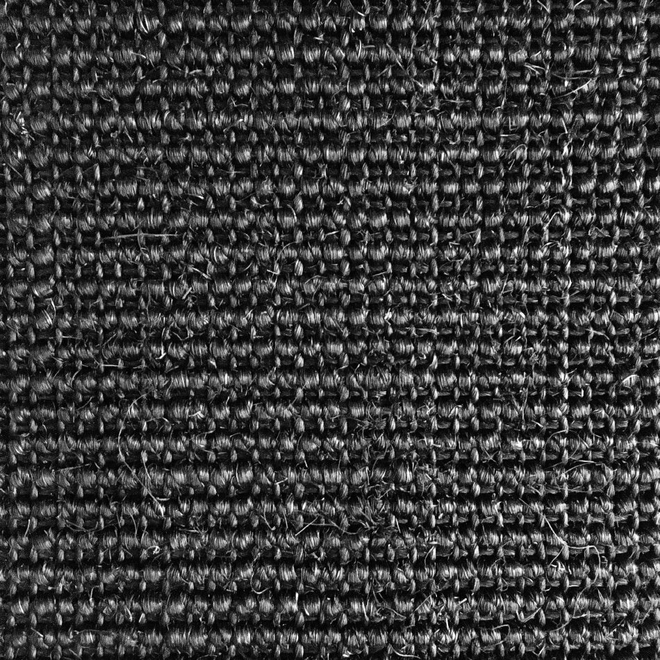 Dark, finely ribbed sisal fabric with a precise grid texture, showcasing refined craftsmanship and natural fibre depth.