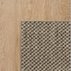 Overlock border rug in a natural fibre, showcased on light timber flooring for an elegant, refined interior finish.