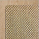 Tuck Under Border wool and jute rug, natural fibers woven with precision, sits on pale timber flooring in an elegantly styled space.