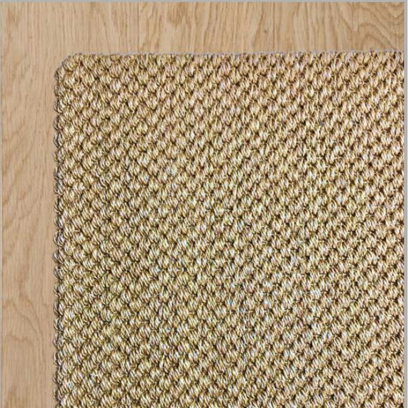 Tuck Under Border wool and jute rug, natural fibers woven with precision, sits on pale timber flooring in an elegantly styled space.