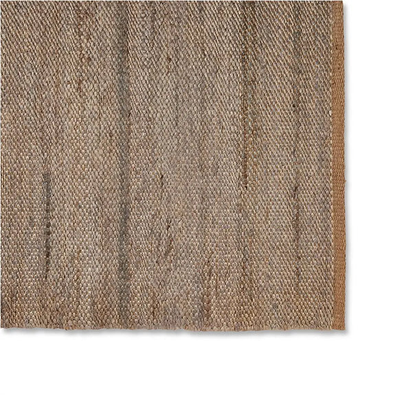 Detailed view of a jute rug in soft frost grey with textured brown and beige patterns, highlighting fine natural fibre weave.