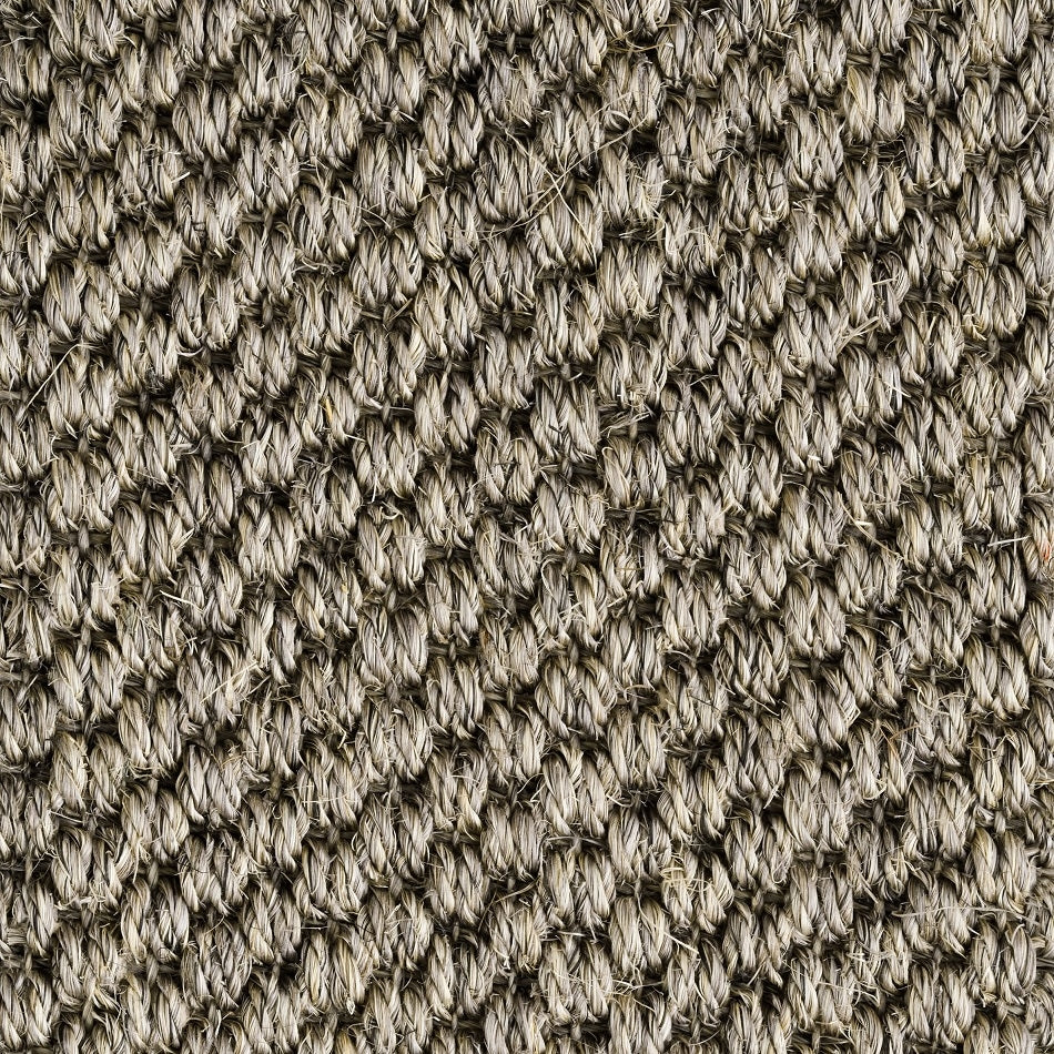 Detailed view of rustic granite sisal carpet, showcasing thick, interwoven natural fibres and crafted texture.