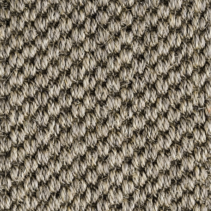 Detailed view of rustic granite sisal carpet, showcasing thick, interwoven natural fibres and crafted texture.