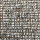 Thick, textured loops of beige, white, brown and gray wool and jute fibres create a refined, natural woven surface.