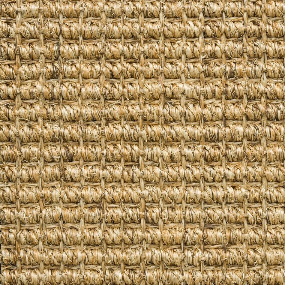 Detailed view of thick, interwoven natural sisal fibers highlighting rich texture and refined craftsmanship in sustainable flooring.