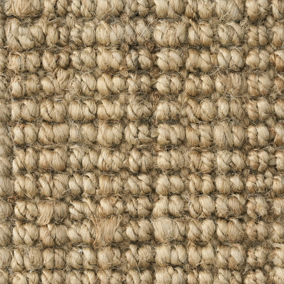 Detailed view of a finely woven, light tan jute floorcovering showcasing its natural texture and artisanal craftsmanship.