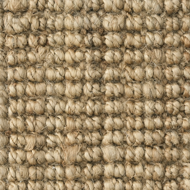Detailed view of a finely woven, light tan jute floorcovering showcasing its natural texture and artisanal craftsmanship.