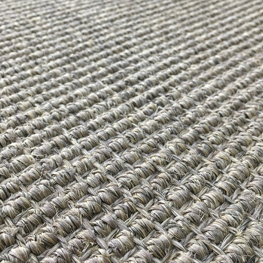 Heavy ribbed sisal rug in granite, woven in a beige and brown grid, showcasing refined natural texture and artisan detail.