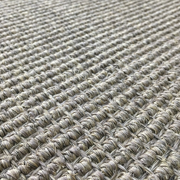 Heavy ribbed sisal rug in granite, woven in a beige and brown grid, showcasing refined natural texture and artisan detail.