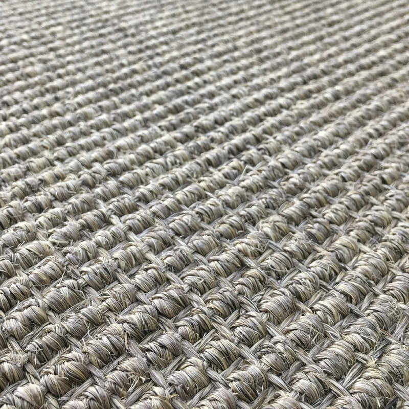 Heavy ribbed sisal rug in granite, woven in a beige and brown grid, showcasing refined natural texture and artisan detail.