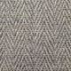 Detailed view of herringbone sisal carpet in soft beige and grey, highlighting refined texture and quality natural fibres.