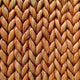 Detailed view of finely woven brown abaca fibres in a herringbone pattern, showcasing artisanal texture and natural elegance.