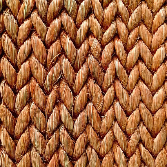 Thick, braided abaca rug in a refined chevron pattern, highlighting rich texture and artisanal craftsmanship.