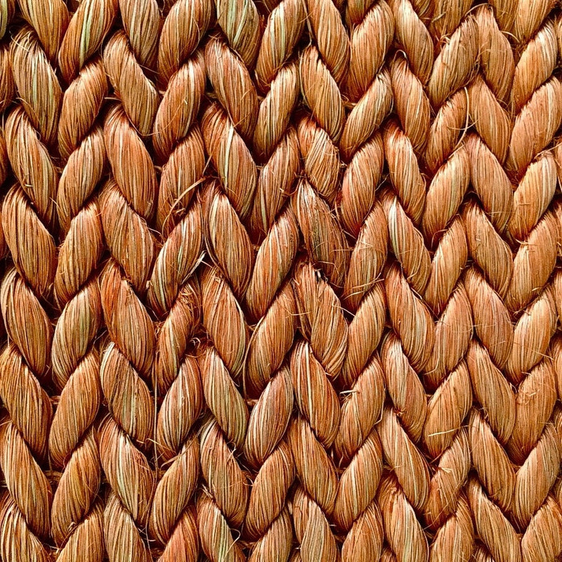 Thick, braided abaca rug in a refined chevron pattern, highlighting rich texture and artisanal craftsmanship.
