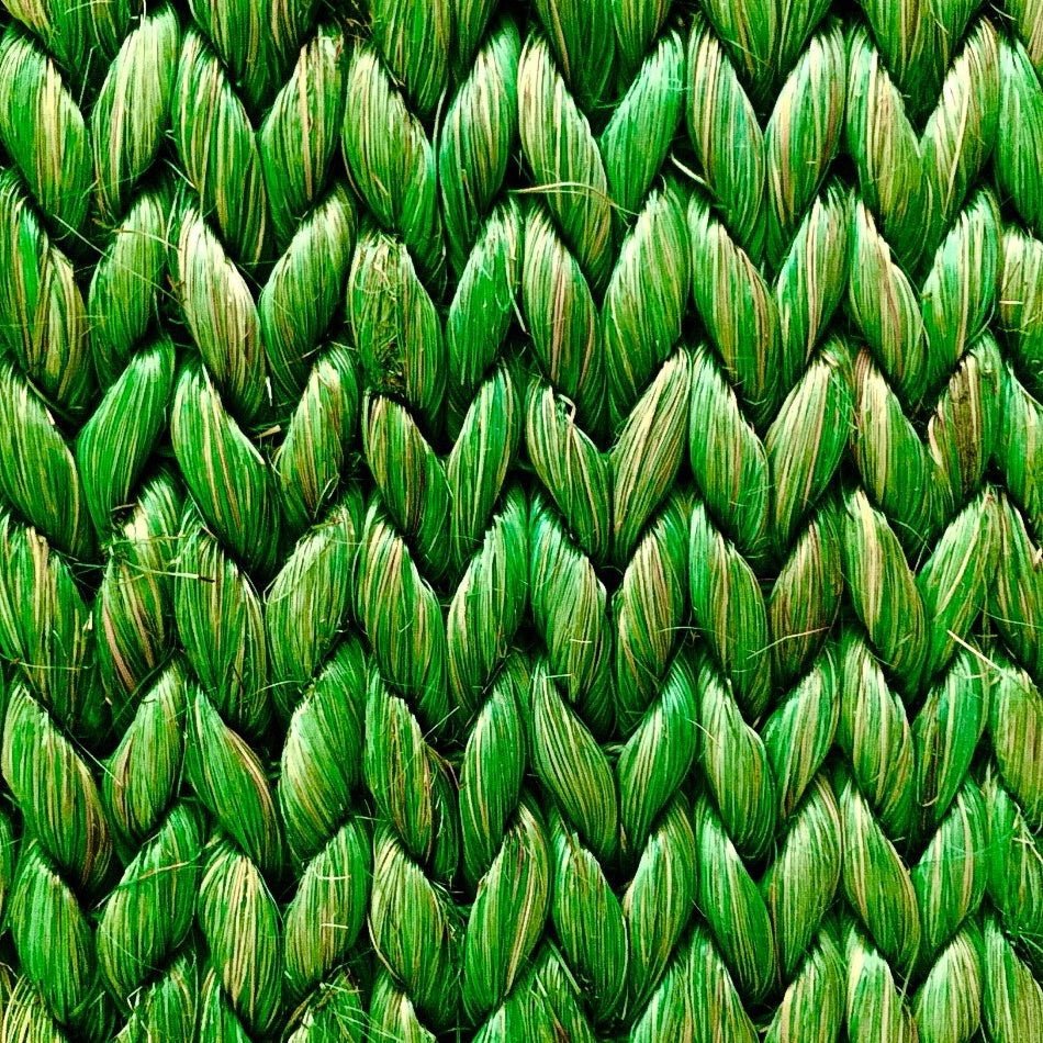 Detailed view of a herringbone pattern in textured green abaca, showcasing its rich weave and sustainable craftsmanship.