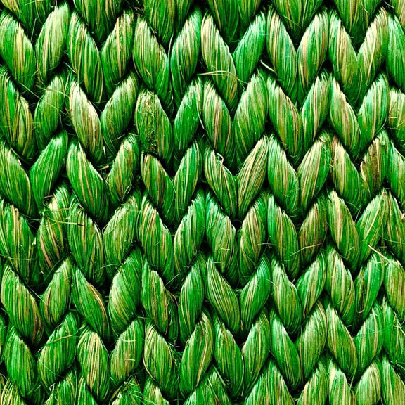 Detailed view of a herringbone pattern in textured green abaca, showcasing its rich weave and sustainable craftsmanship.