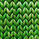 Detailed view of a herringbone pattern in textured green abaca, showcasing its rich weave and sustainable craftsmanship.