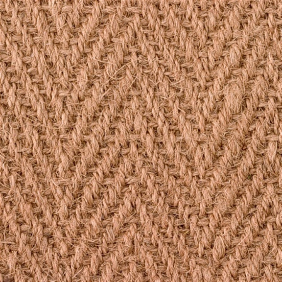 Detailed view of a herringbone coir rug, showcasing handwoven jute texture and warm natural brown fibres.