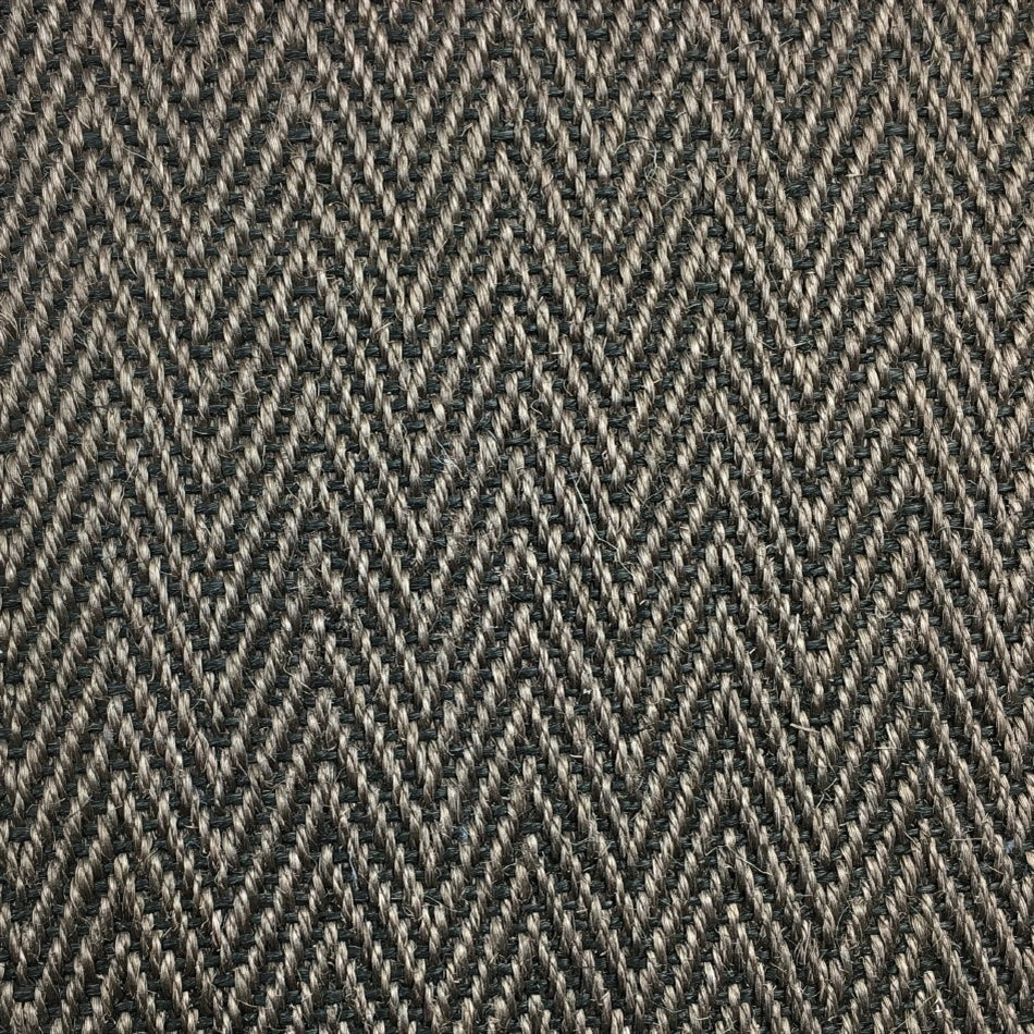 Detailed view of a herringbone sisal rug in textured grey and black, showcasing fine craftsmanship and natural fibre quality.