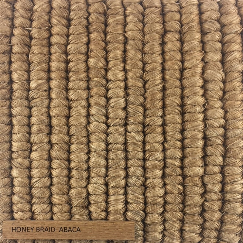 Detailed view of thick, hand-braided abaca fibres in a warm honey tone, showcasing natural texture and artisanal quality.