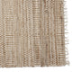 A refined runner with soft beige and white stripes, tactile tassels, and a natural woven texture enhances an elegant home interior.