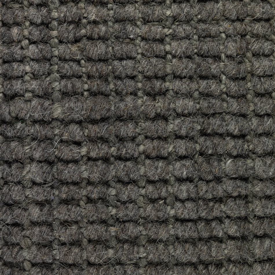 Detail of a Mineral Grey wool and jute rug, showcasing thick, textured grid weave and refined natural fibre craftsmanship.
