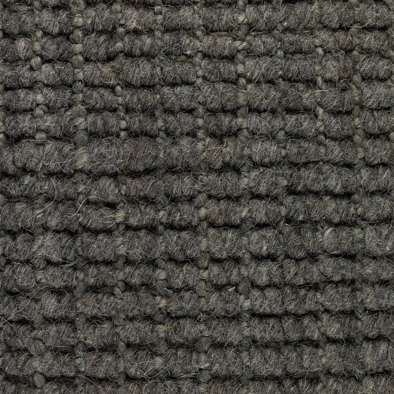 Detail of a Mineral Grey wool and jute rug, showcasing thick, textured grid weave and refined natural fibre craftsmanship.