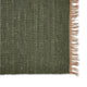 Close-up of an olive green jute rug with beige fringe, highlighting the rich texture and natural fibers on a white background.