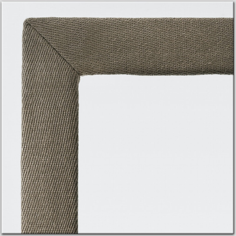 Detail of a cotton and linen frame corner showcasing textured natural fibres and refined craftsmanship on premium flooring.