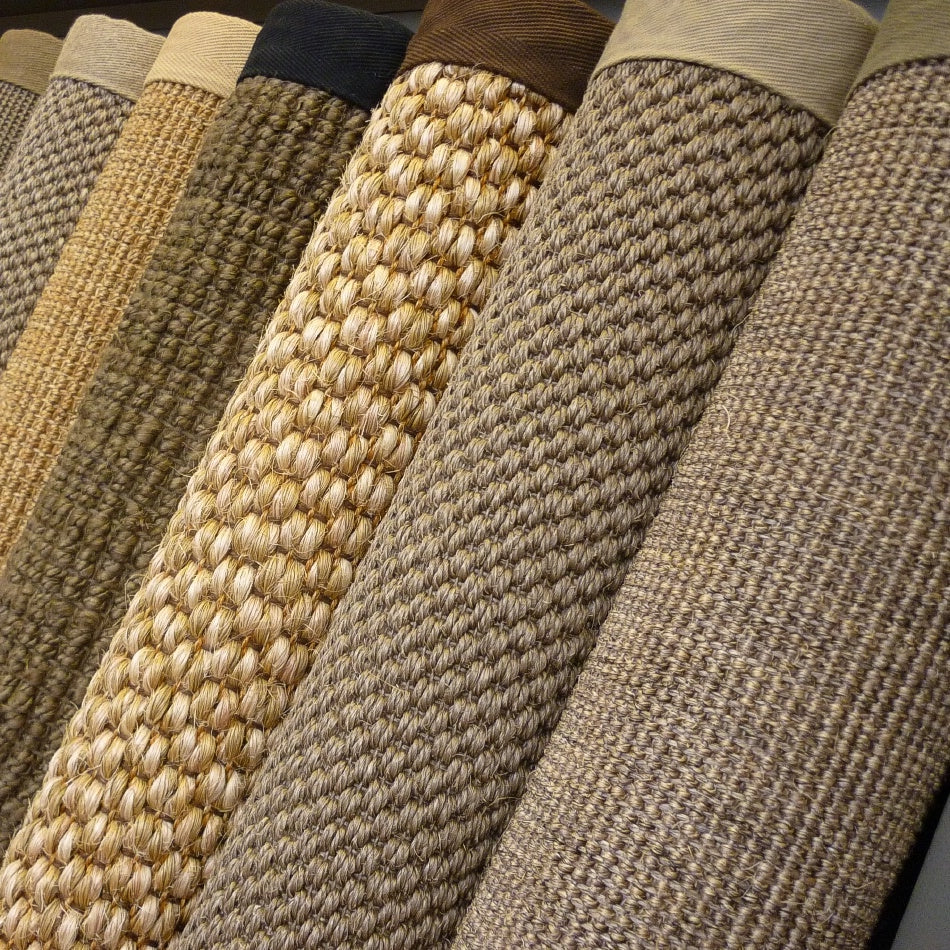 Beige and brown natural fibre flooring with crisp cotton and linen borders, styled in a refined, light-filled Australian interior.
