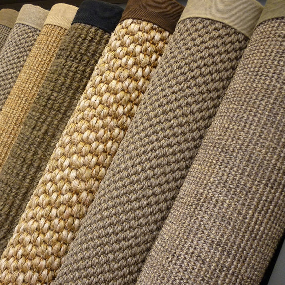 Beige and brown natural fibre flooring with crisp cotton and linen borders, styled in a refined, light-filled Australian interior.