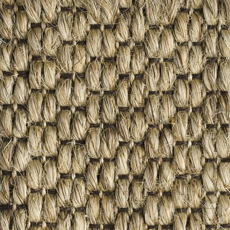 Textured sisal mat in beige and brown, woven in a rich, rustic pattern that highlights artisanal craftsmanship and natural fibres.