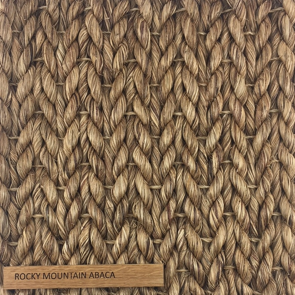 Detailed view of thick, hand-braided natural fibers in a refined herringbone weave; label reads Abaca - Rocky Mountain.