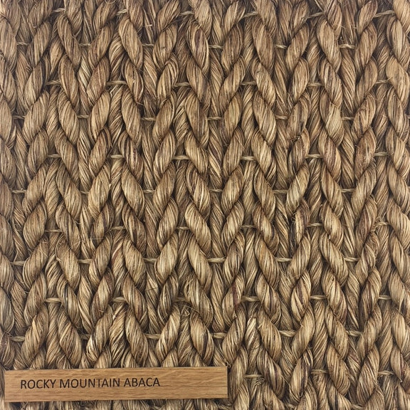Detailed view of thick, hand-braided natural fibers in a refined herringbone weave; label reads Abaca - Rocky Mountain.