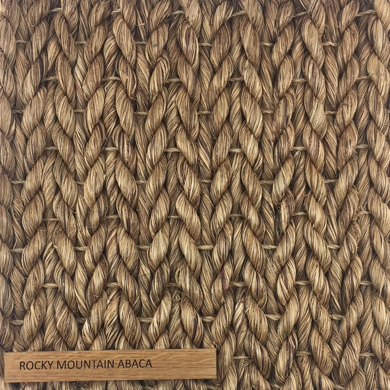Detailed view of thick, hand-braided natural fibers in a refined herringbone weave; label reads Abaca - Rocky Mountain.