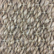 Thick, twisted natural abaca fibers woven in a refined crisscross pattern, showcasing artisanal craftsmanship and durability.