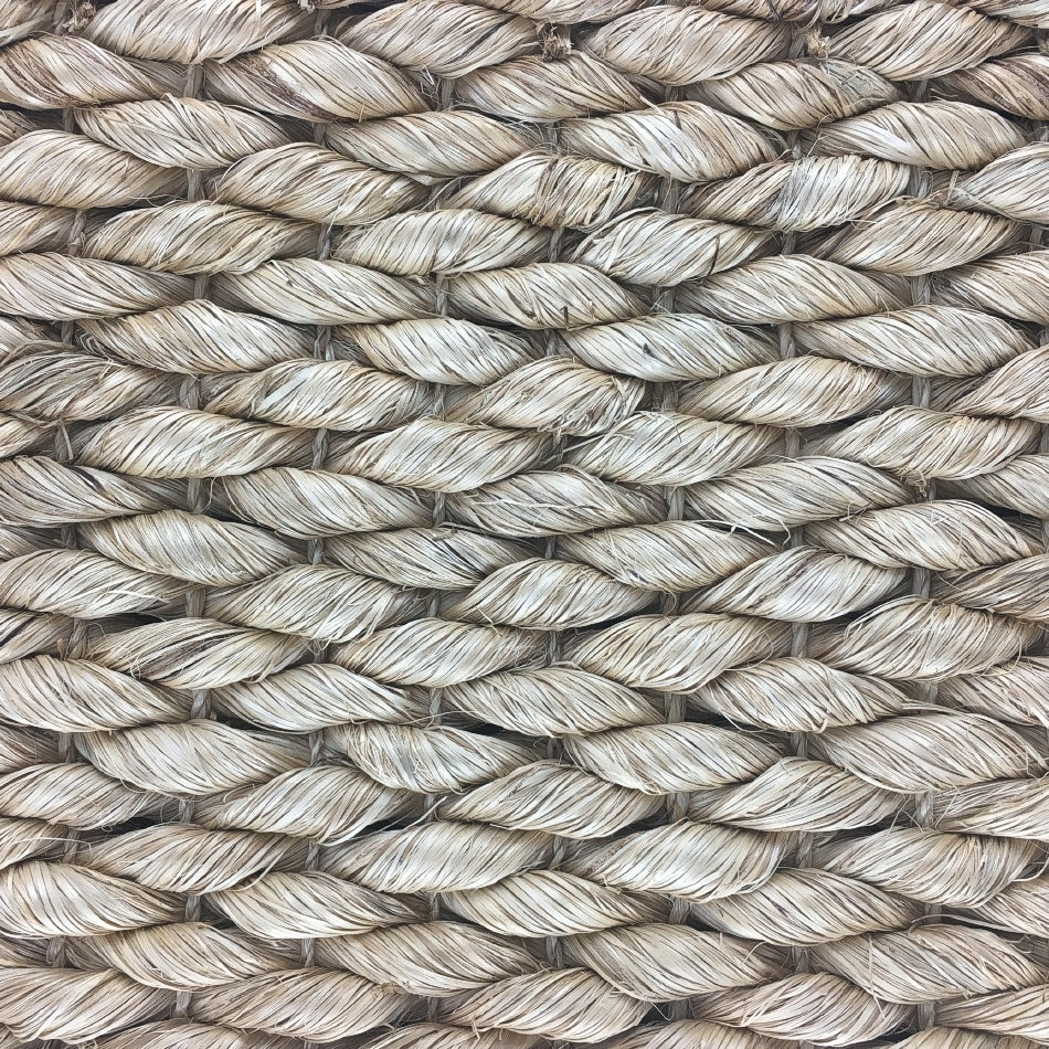 Thick beige natural fibre rope strands woven in an intricate, durable pattern, highlighting artisanal craftsmanship and quality.
