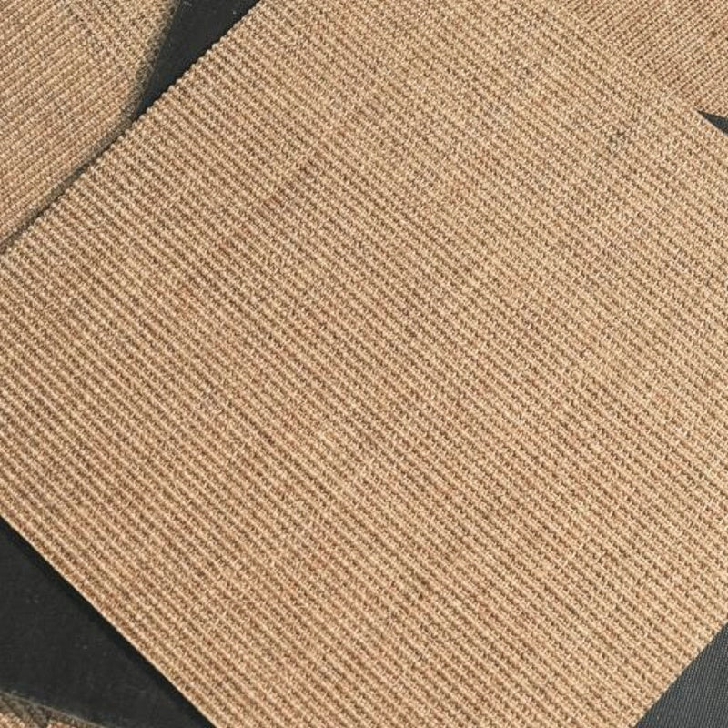 Detailed view of handwoven sisal tiles, displayed at an angle on a dark surface, highlighting natural texture and refined quality.