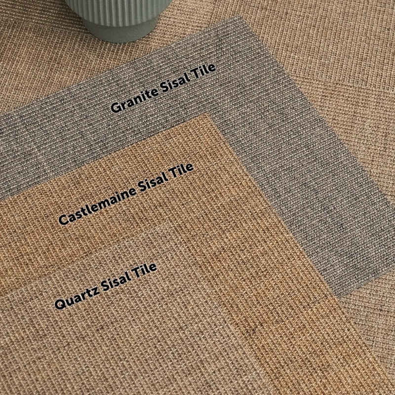 Three natural sisal tiles are arranged on a textured surface with a round ceramic pot, showcasing refined, sustainable fibres.