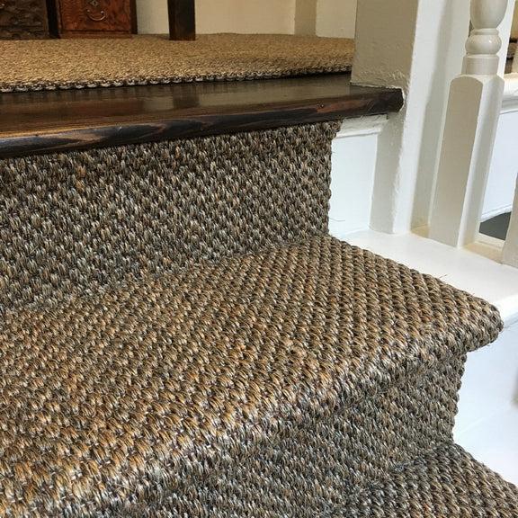 Elegant staircase featuring a Fine Rustic Slate Sisal runner and crisp white-painted wood trim in a refined, light-filled interior.