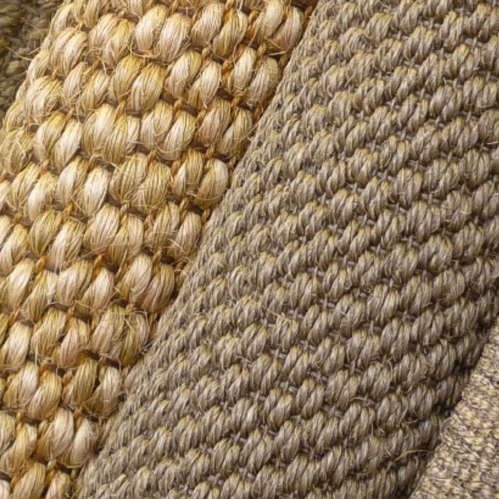 Detailed view of tan and beige woven natural fibre flooring, highlighting fine craftsmanship and tightly knit textures.